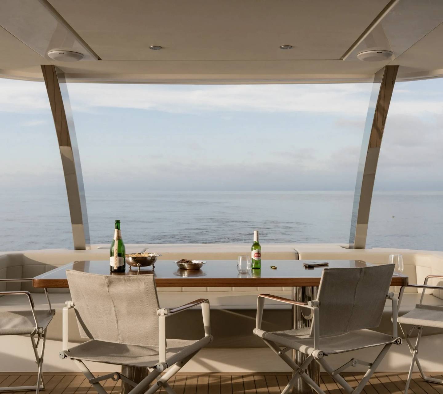Yacht deck with chairs and ocean view.