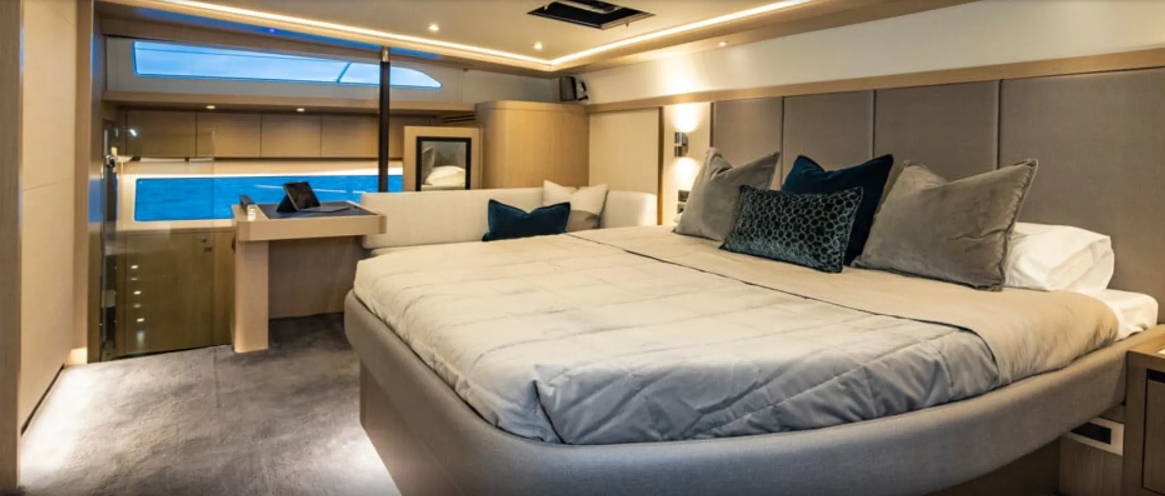 Luxurious yacht bedroom with ocean view.