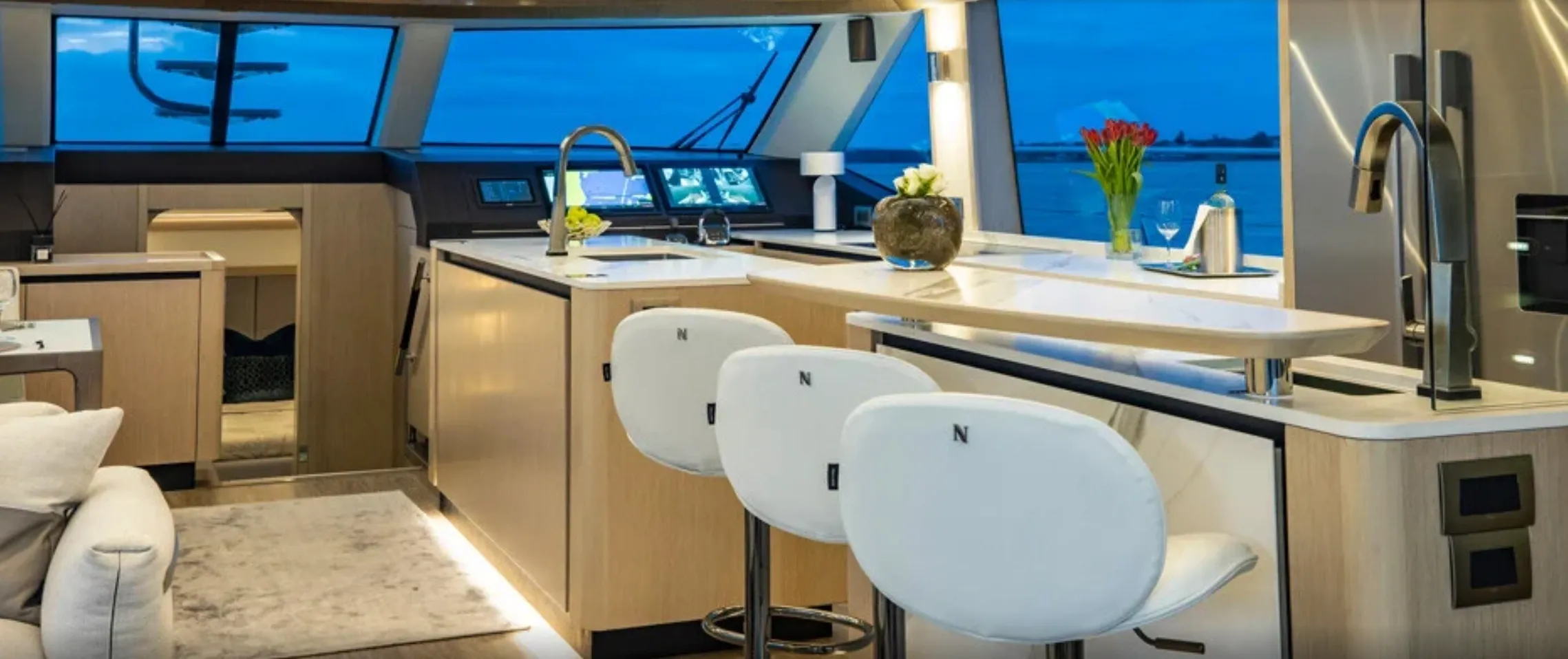 Luxury yacht interior with modern kitchen area.