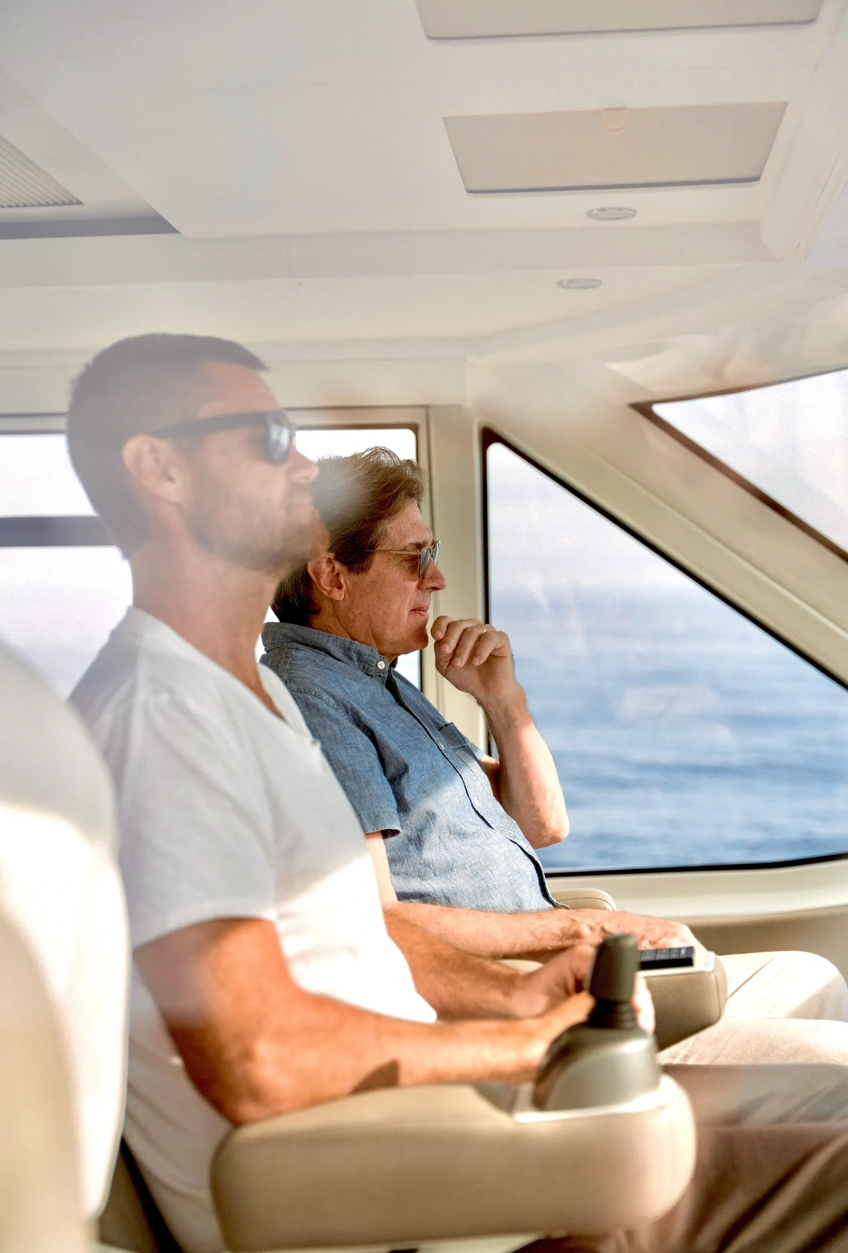 Two men seated inside a vehicle.