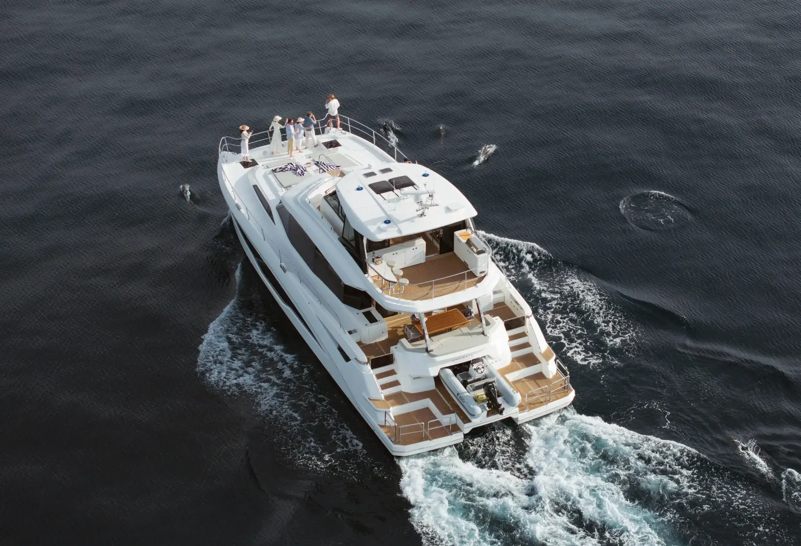 Luxury yacht sailing on calm ocean waters.