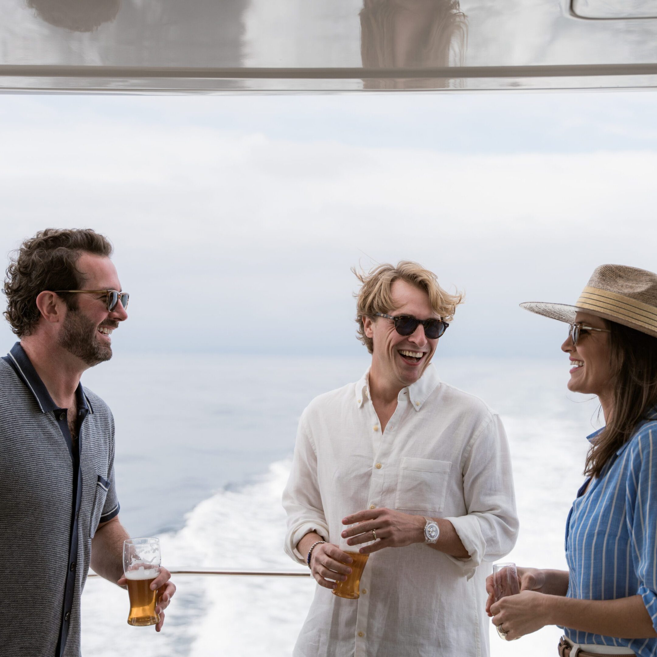 Three people talking on a boat.